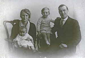 This is a family picture of Gladys, husband Alfred and children Eric(Center) and Irene on her mother's lap. Picture Circa 1925.